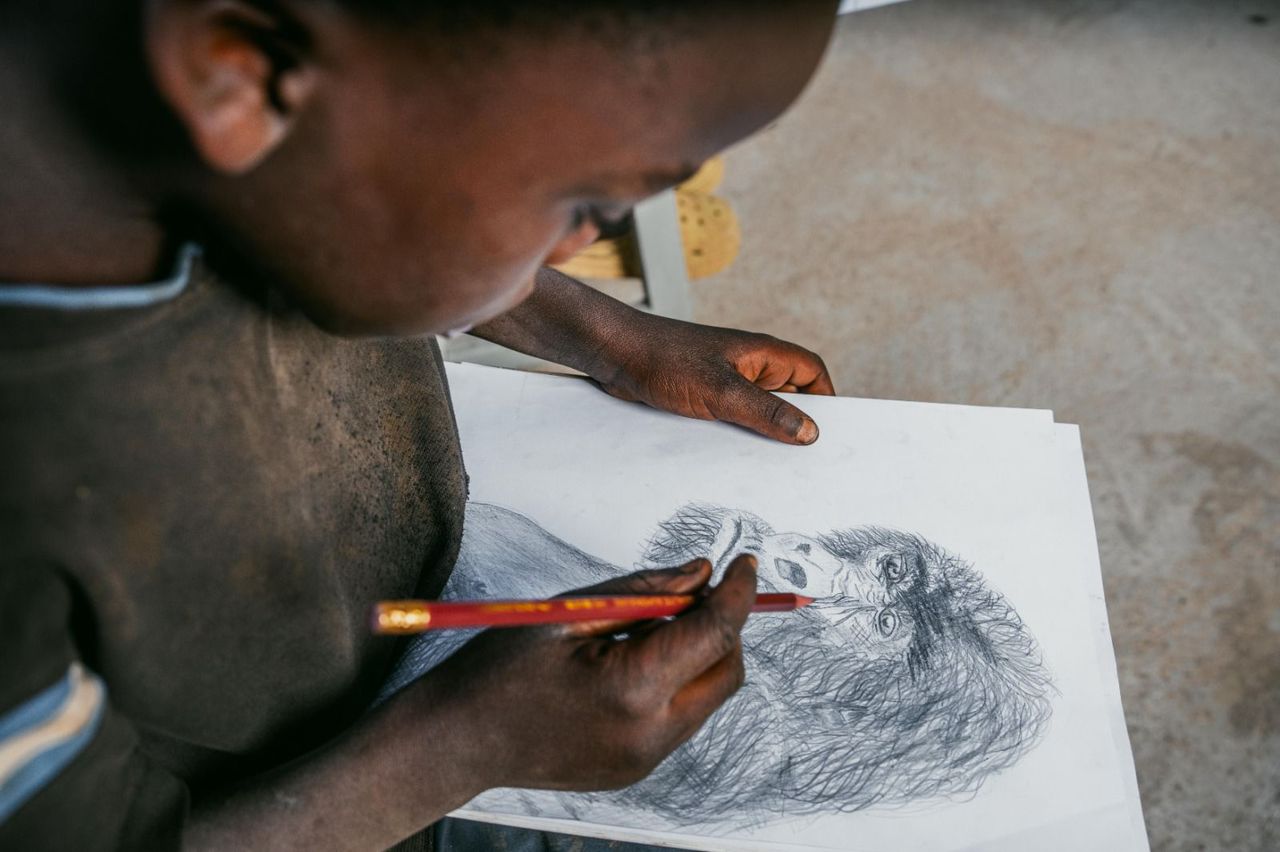 Child drawing a gorilla portrait at Volcano Arts Center